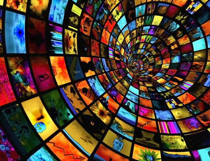 Countless television screens lining a tunnel