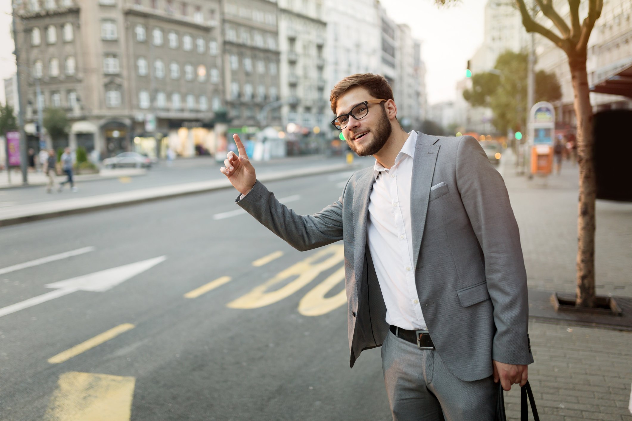 Man in suit hailing a taxi