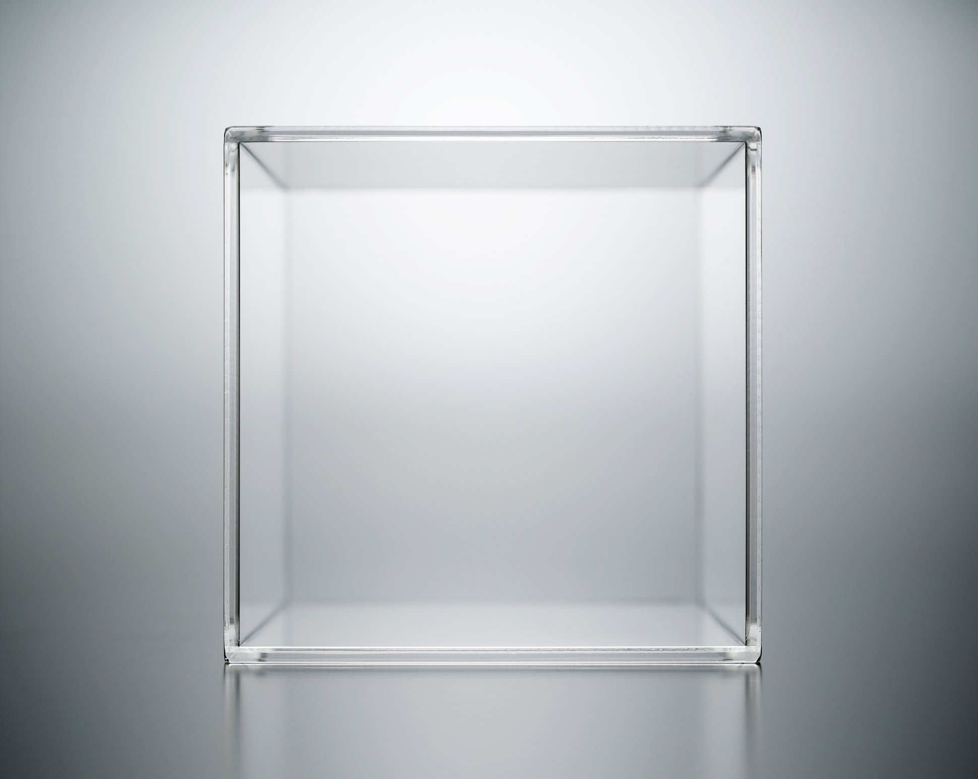 A transparent acrylic box on a luminous grey background.