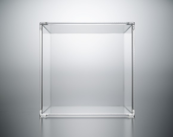 A transparent acrylic box on a luminous grey background.