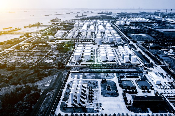 An ariel shot of a refinery by the water.