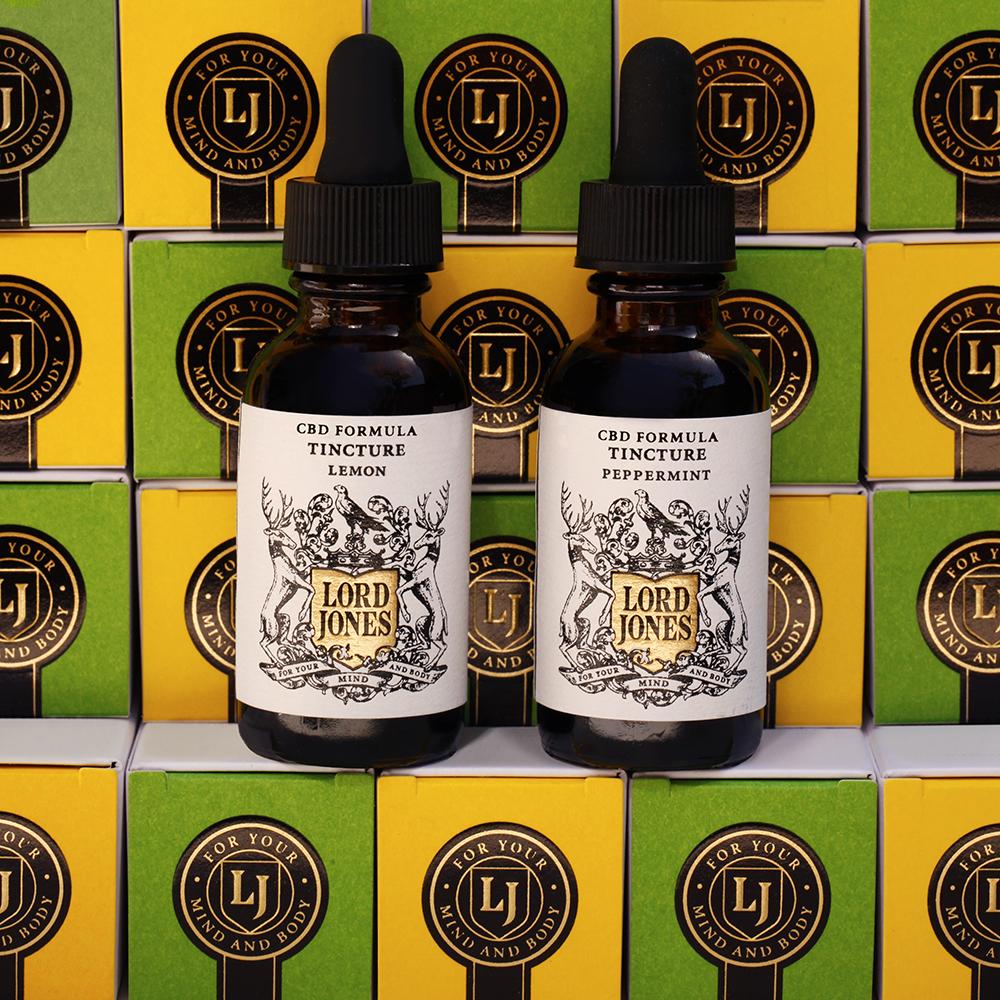Two bottles of Lord Jones tinctures with Lord Jones boxes behind them.