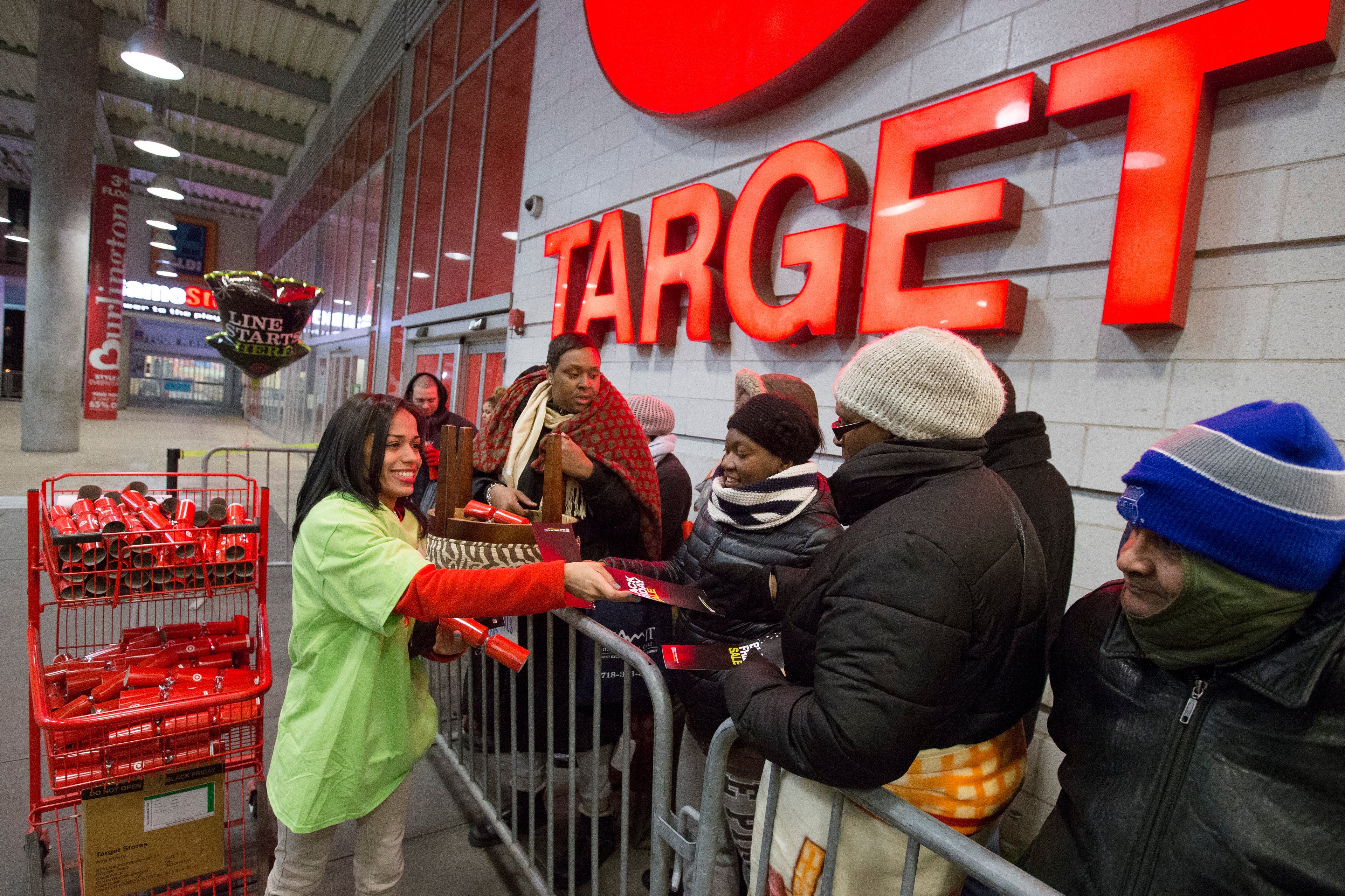 Target employee hands out flyer to shoppers