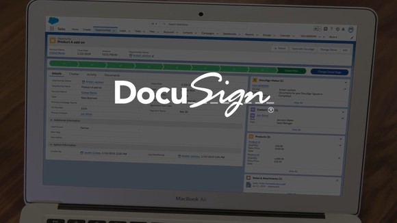 Laptop displaying DocuSign page with DocuSign logo superimposed.