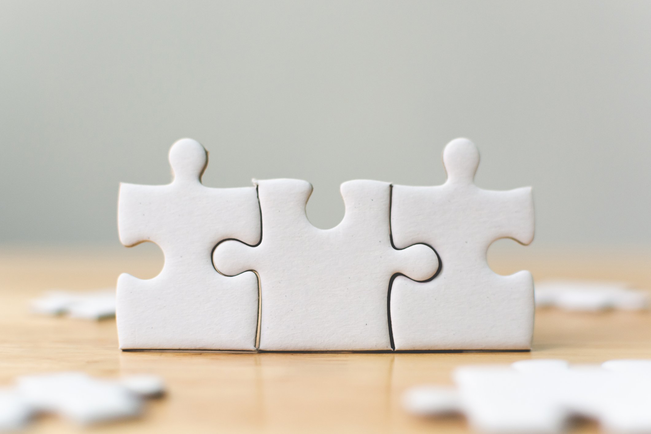 Three connected jigsaw puzzle pieces.