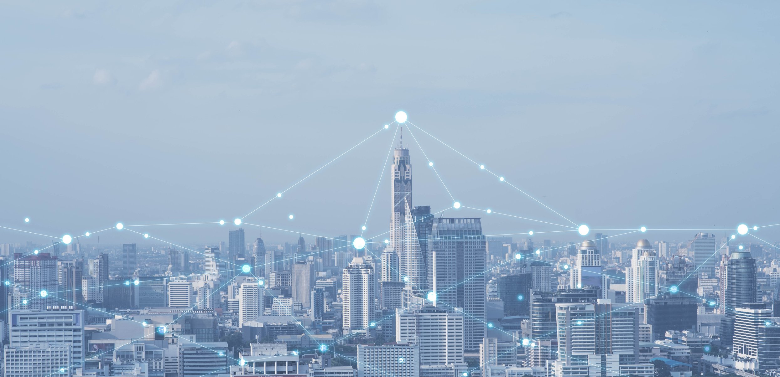 Image of a city skyline with connecting dots on top of buildings.