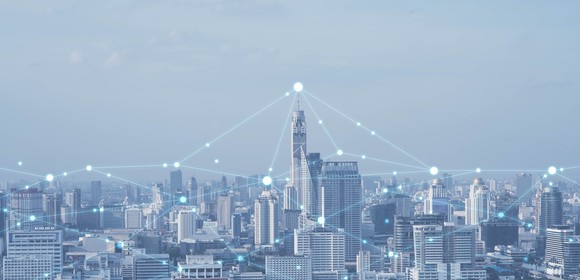 Image of a city skyline with connecting dots on top of buildings.