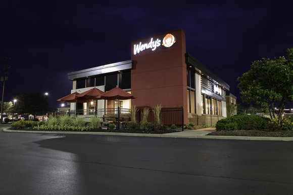 The exterior of a Wendy's restaurant at night.