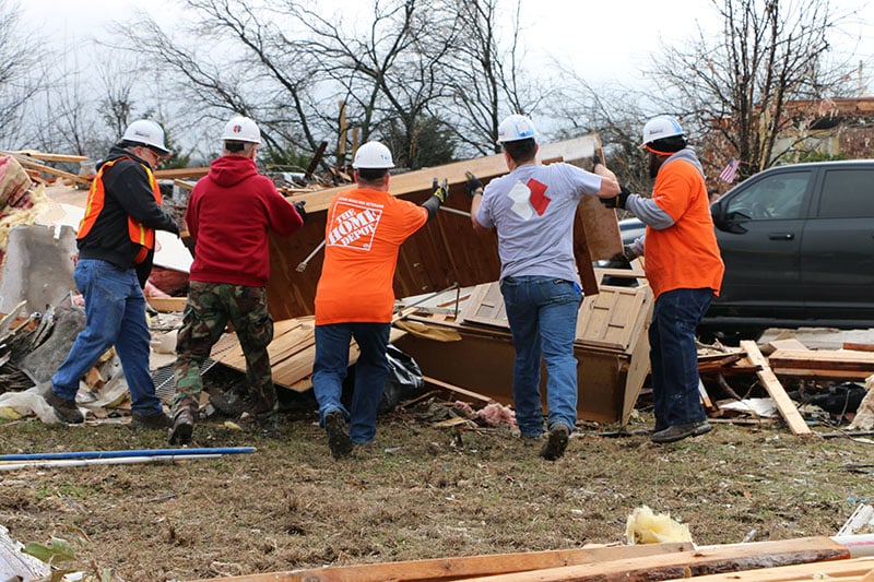 Home Depot employees aiding in a disaster relief effort following a storm.