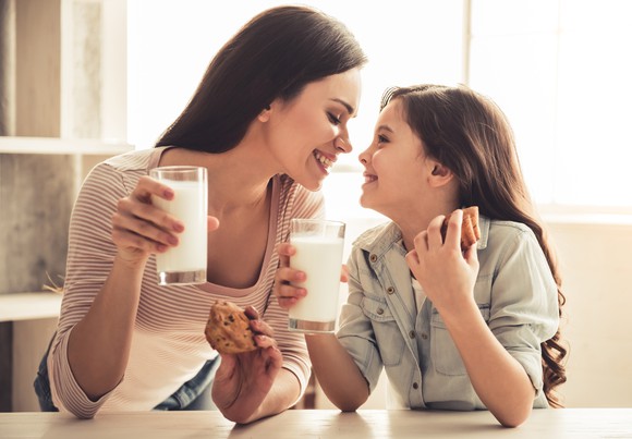 A mother and daughter eating a snack.
