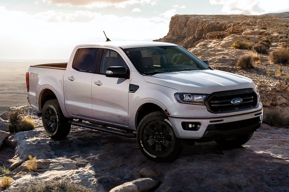 A white Ford Ranger parked near a cliff