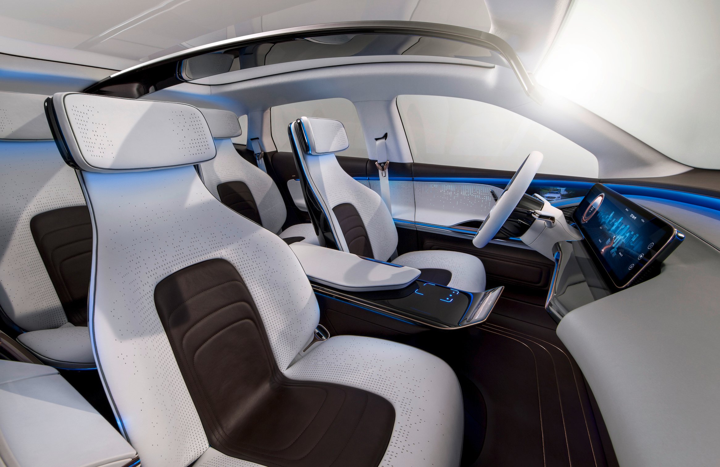 A view of the Generation EQ's interior, showing thin, futuristic seats and a touchscreen dashboard.