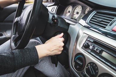 Driver turning key to start a car