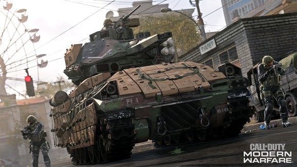 A tank driving in an urban area with soldiers flanking in a screenshot from Call of Duty Modern Warfare.