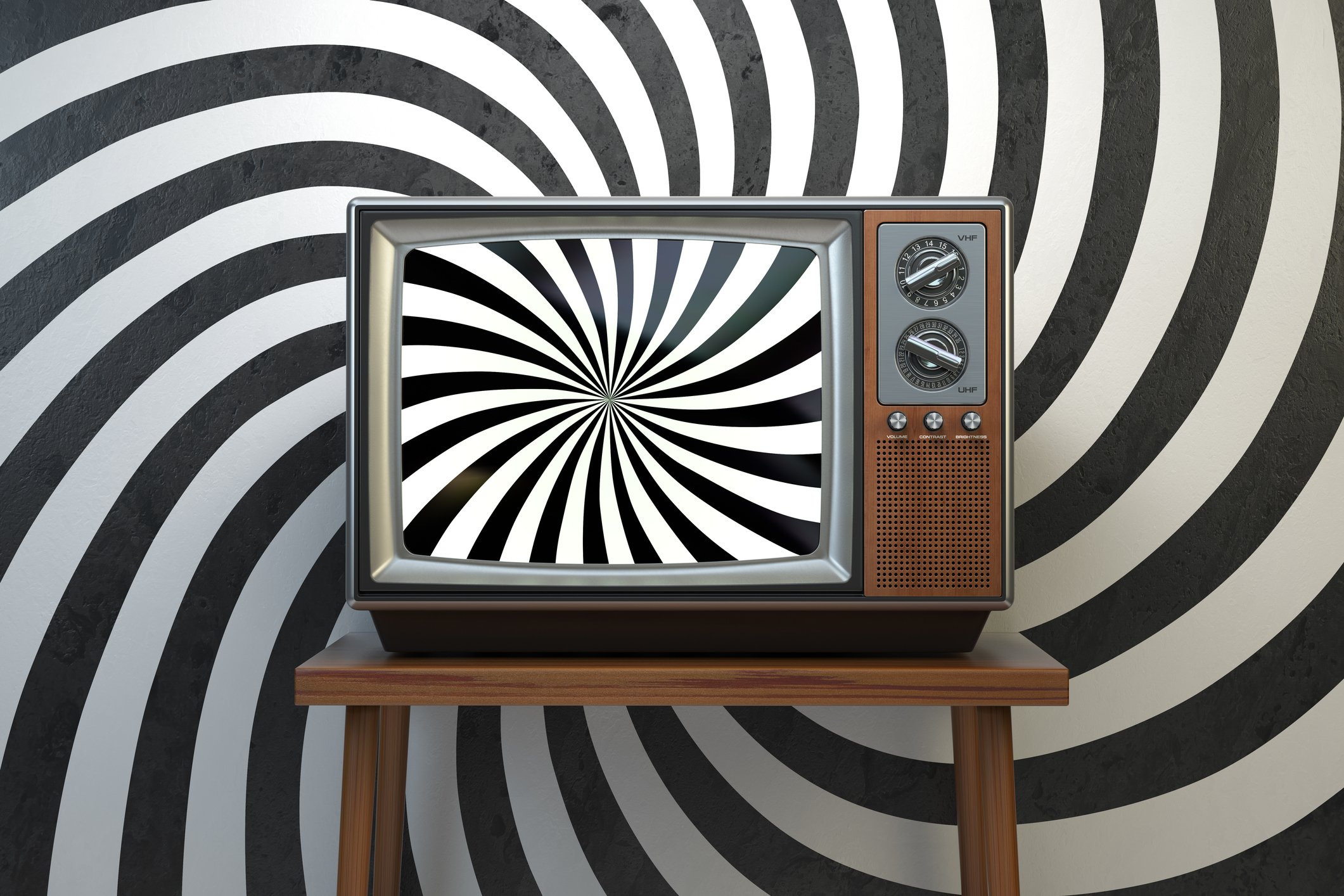 A TV showing a sprial pattern in front of a backdrop showing the same spiral pattern.
