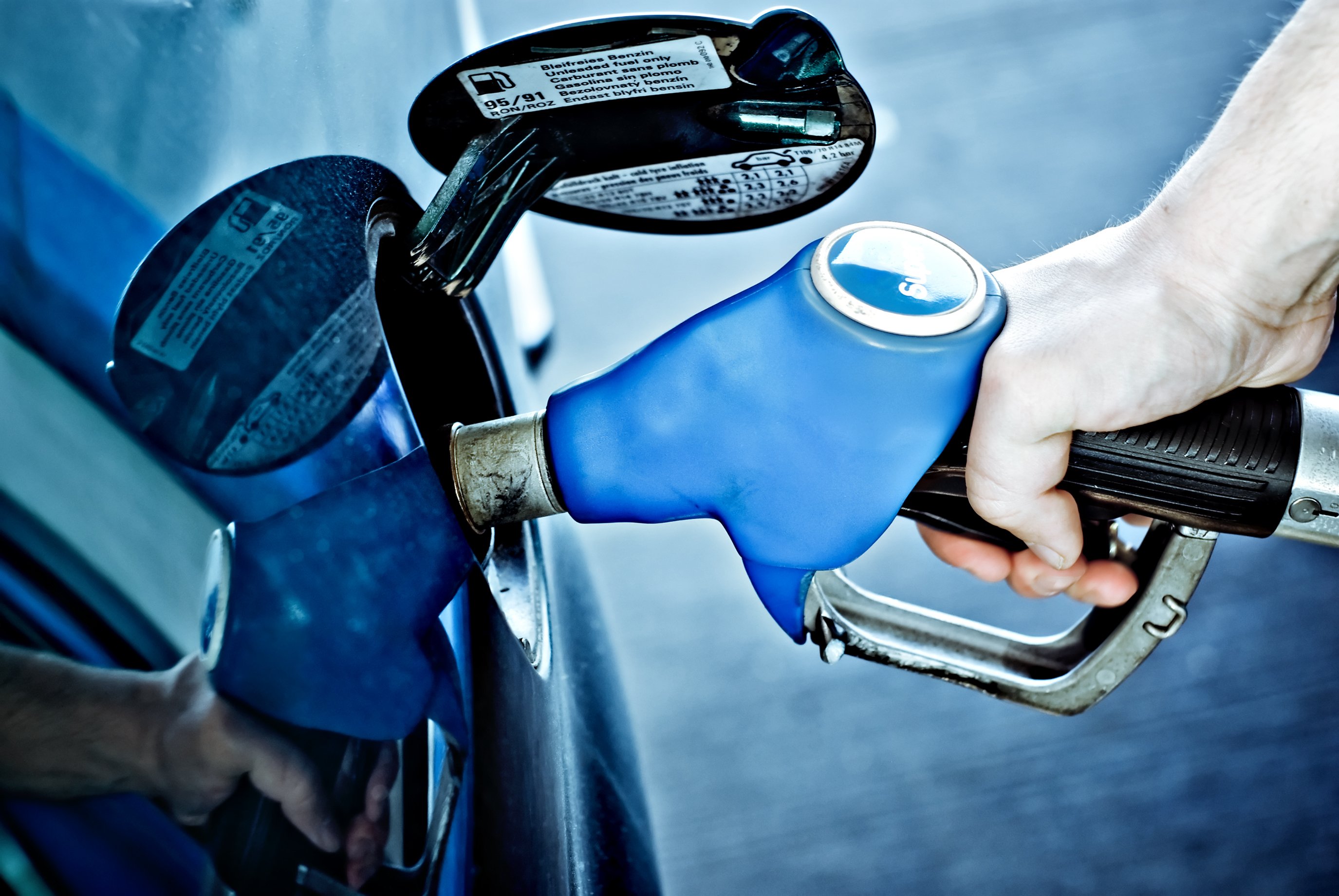 A person filling up their gas tank.