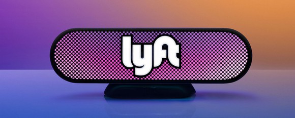 A Lyft beacon on top of a purple dashboard.