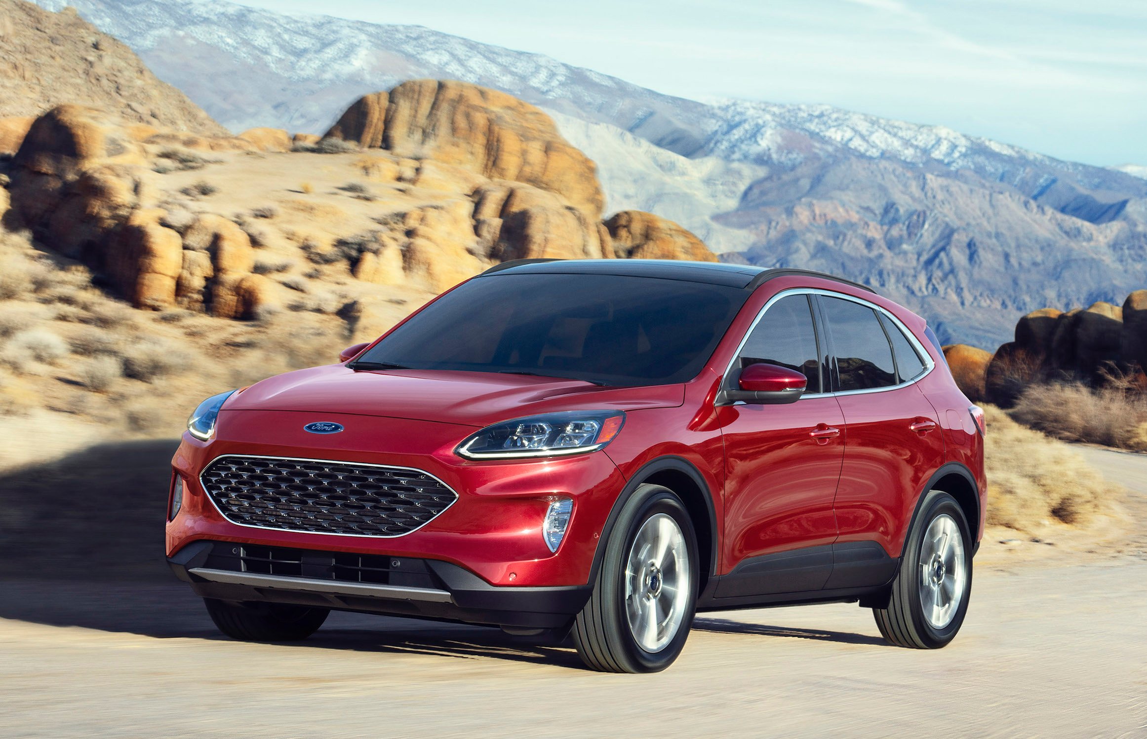 A red 2020 Ford Escape, a compact crossover SUV, on a mountain road.
