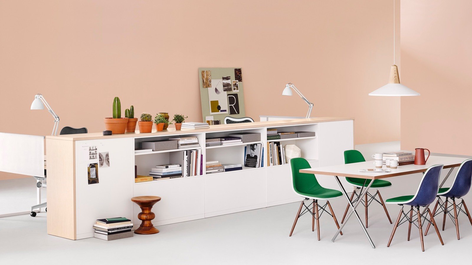 A contemporary office space with work table and a horizontal shelving and storage unit.
