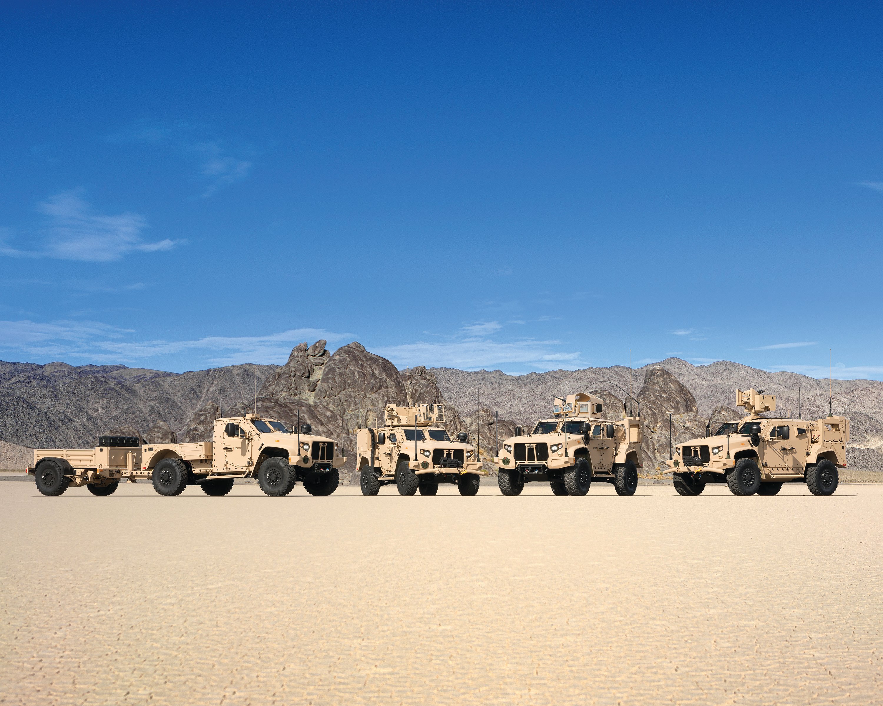 Family photo of four Oshkosh JLTV truck variants