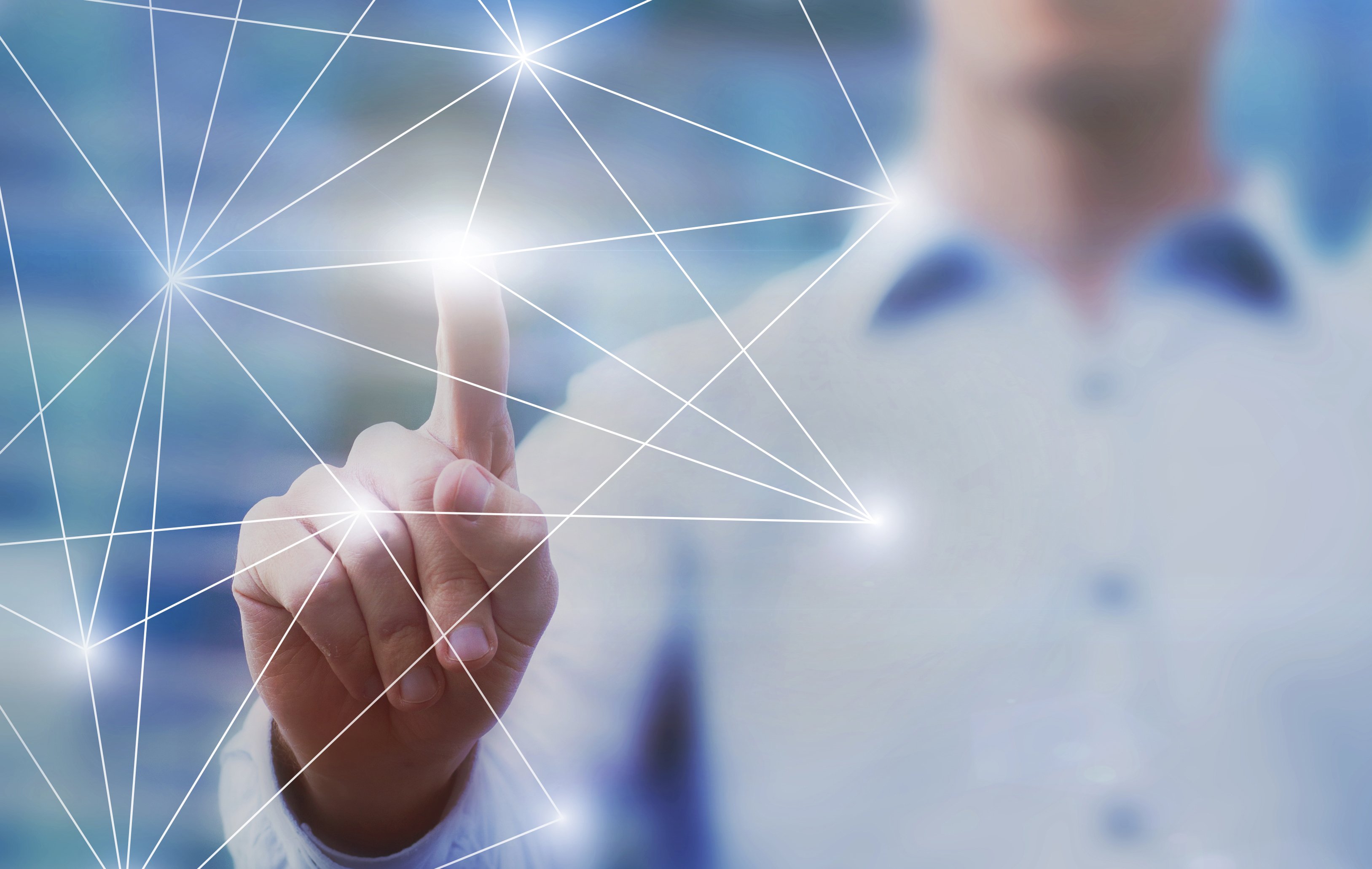 A finger touching a network signalling picking tech stocks