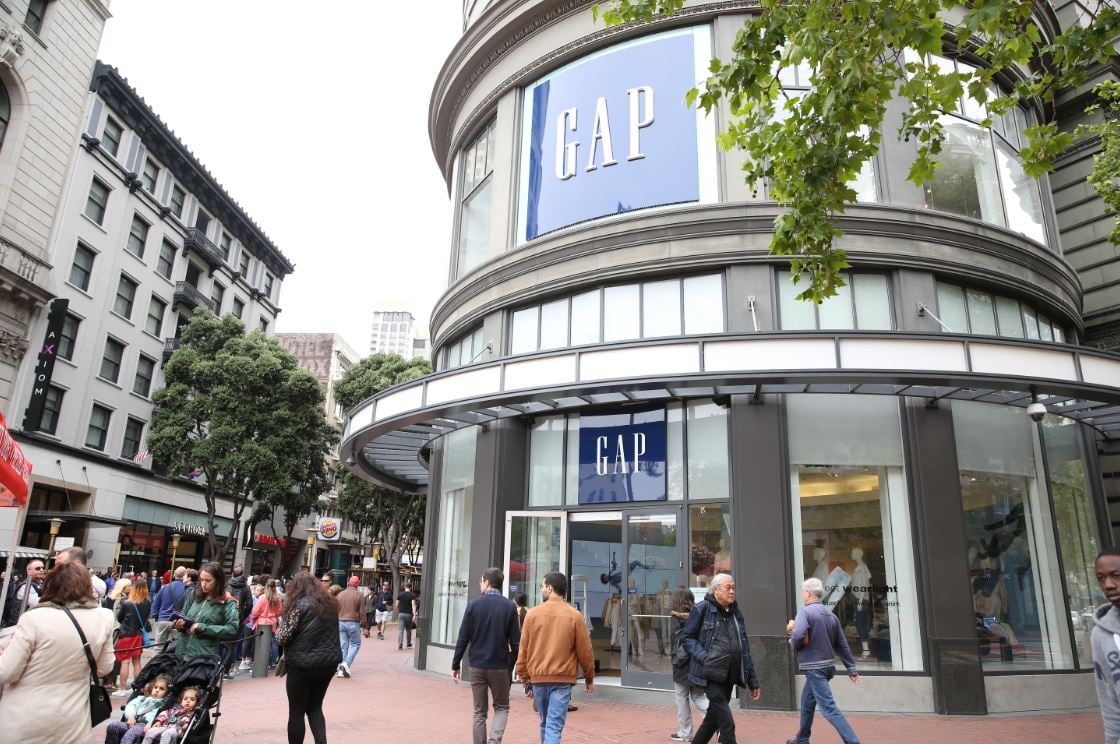 People walking in front of a Gap store