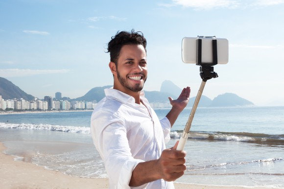 A Brazilian man takes a selfie on the Copacabana beach in Rio de Janeiro.