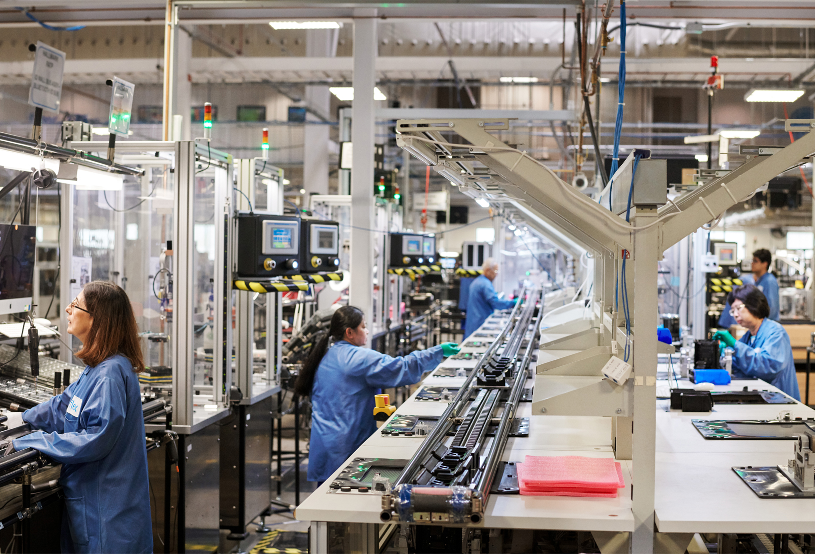 Workers on an assembly line for Mac Pro