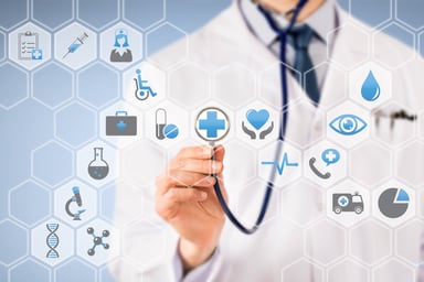 Doctor holding stethoscope to healthcare icons