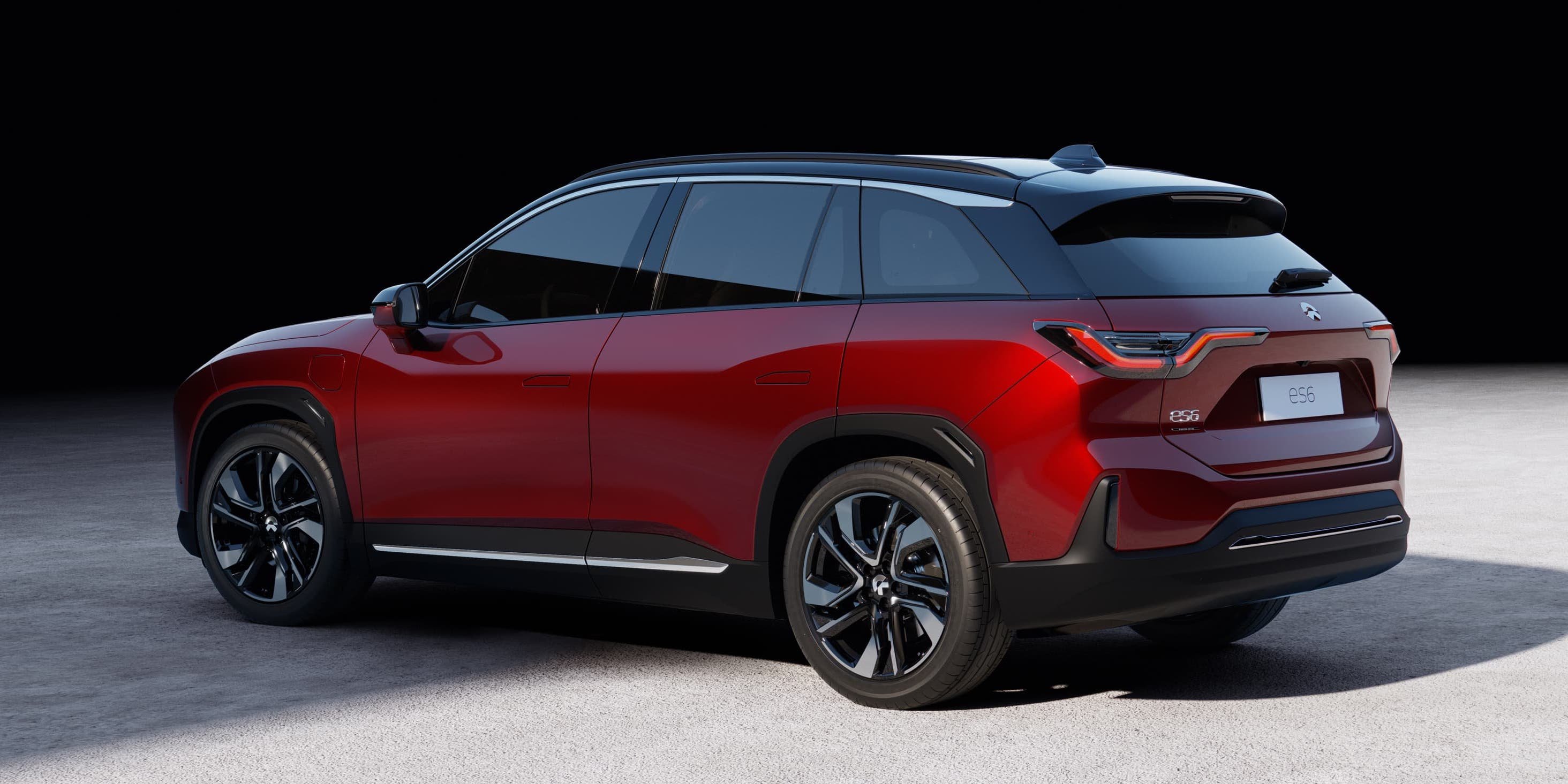 A red NIO ES6, an upscale five-passenger electric crossover SUV.