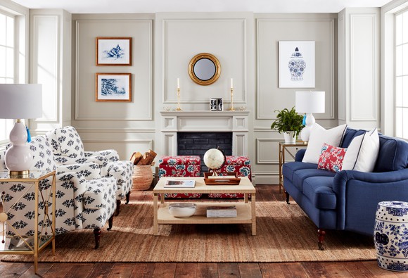 Living room furnished with a couch, two chairs, a coffee table, and a rug