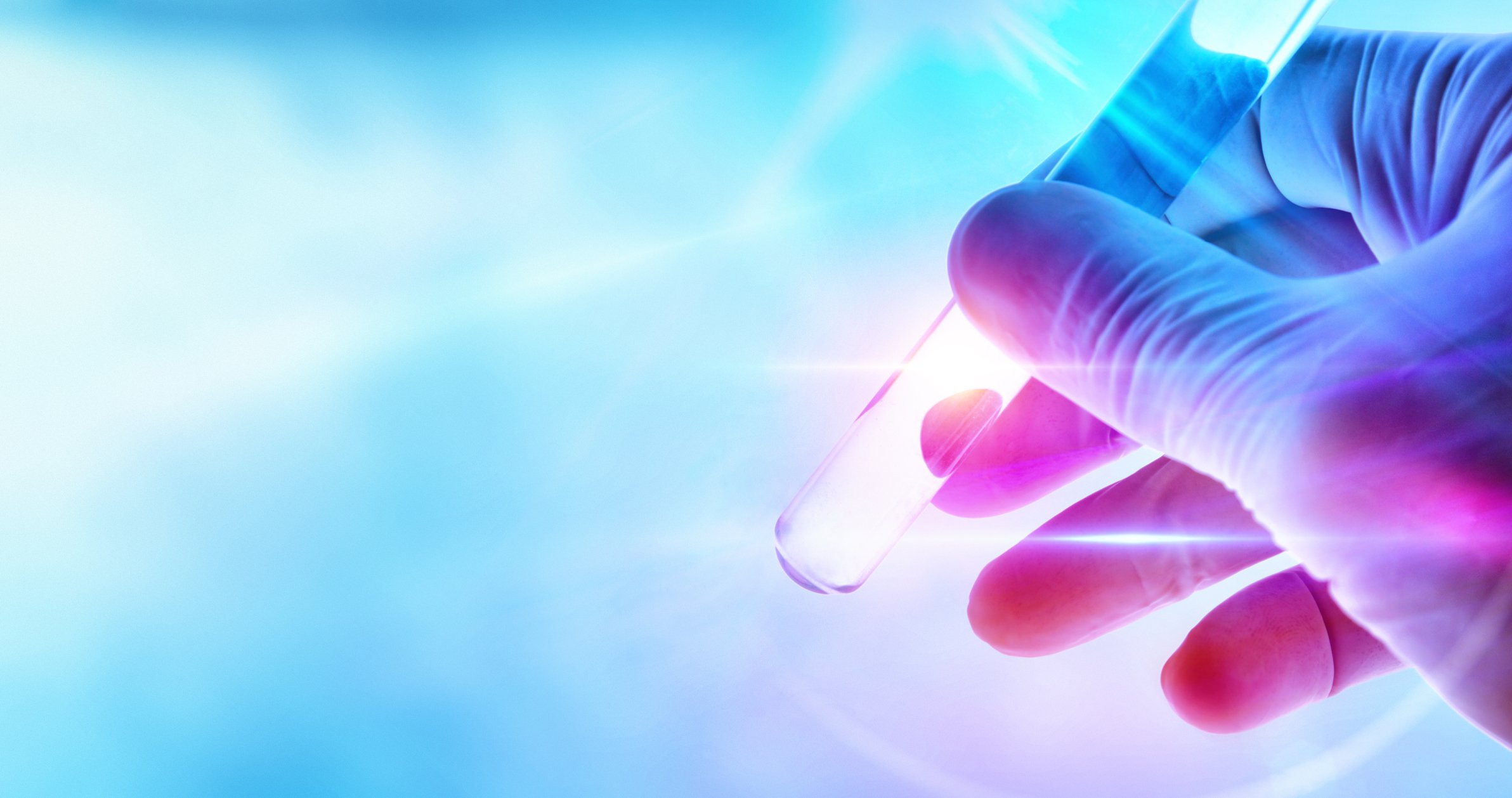 Hand of scientist on test tube