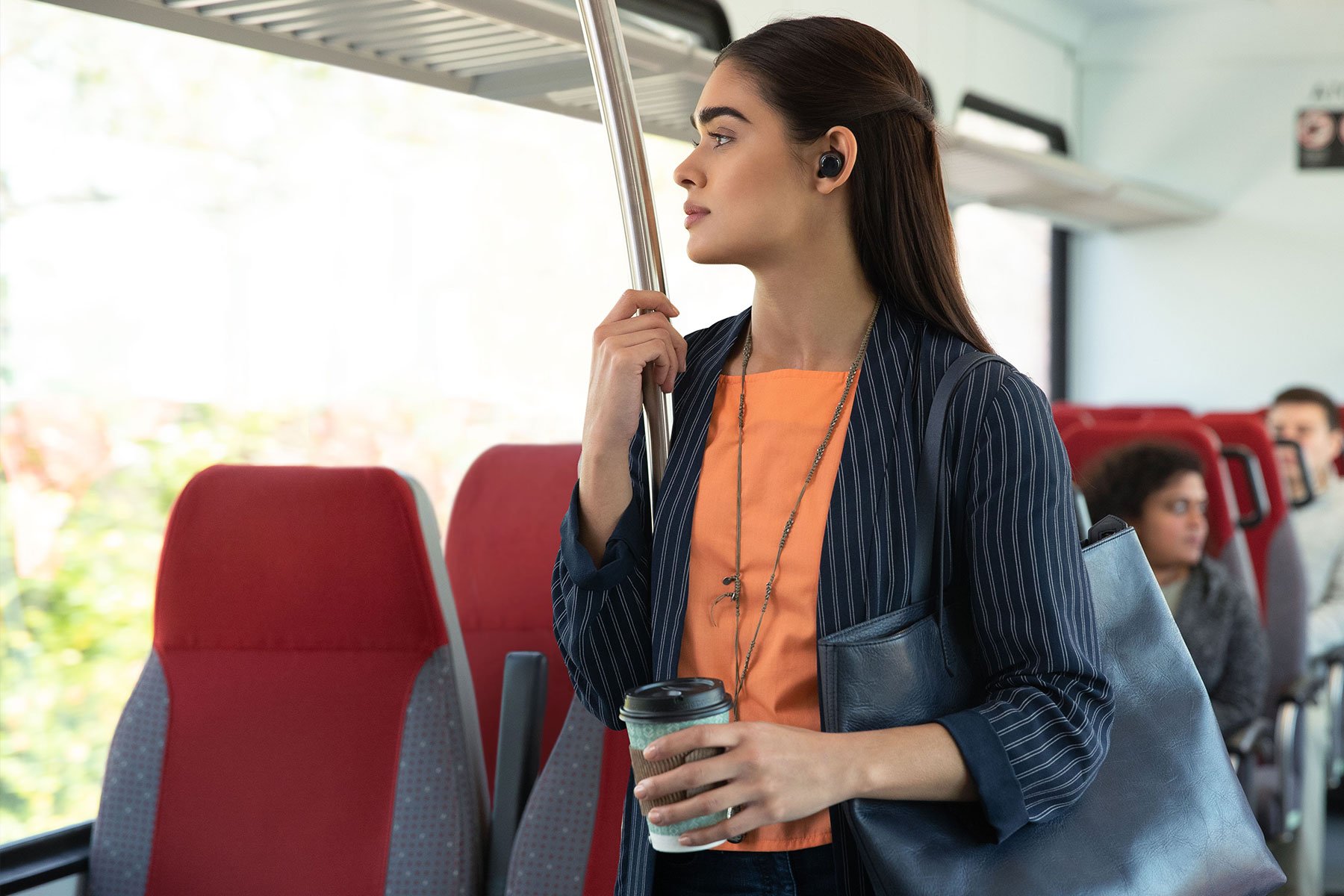 Woman wearing Echo Buds on a bus