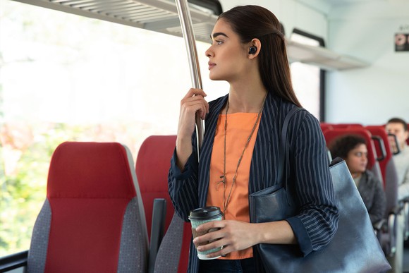 Woman wearing Echo Buds on a bus