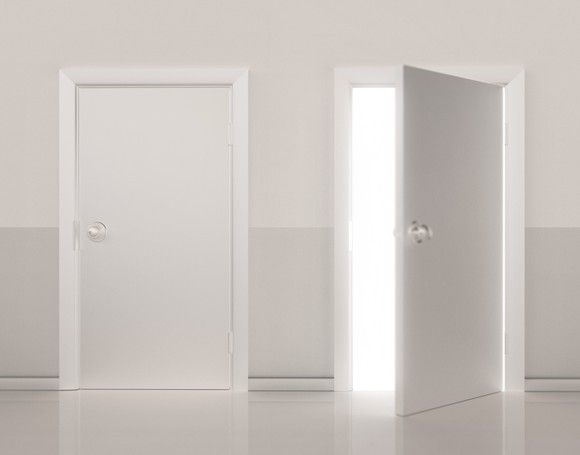 Two white doors with one of them opened.