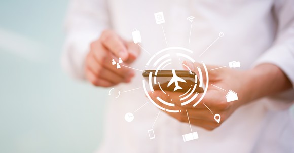 A person accessing a travel app on a smartphone.