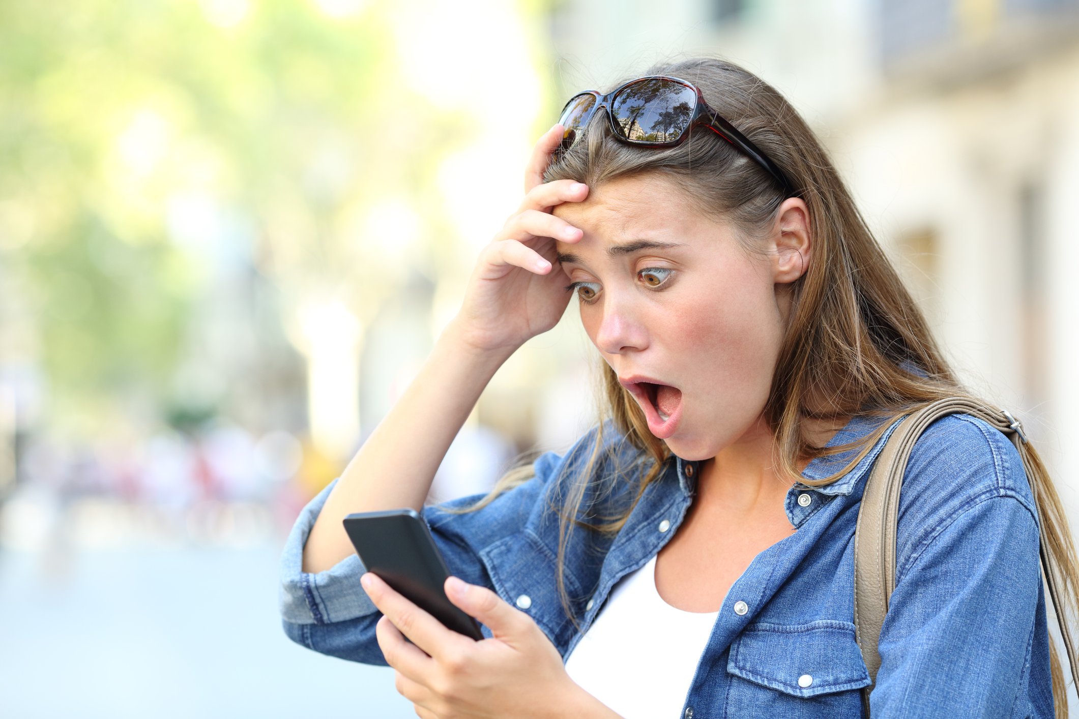 Shocked woman looking at phone