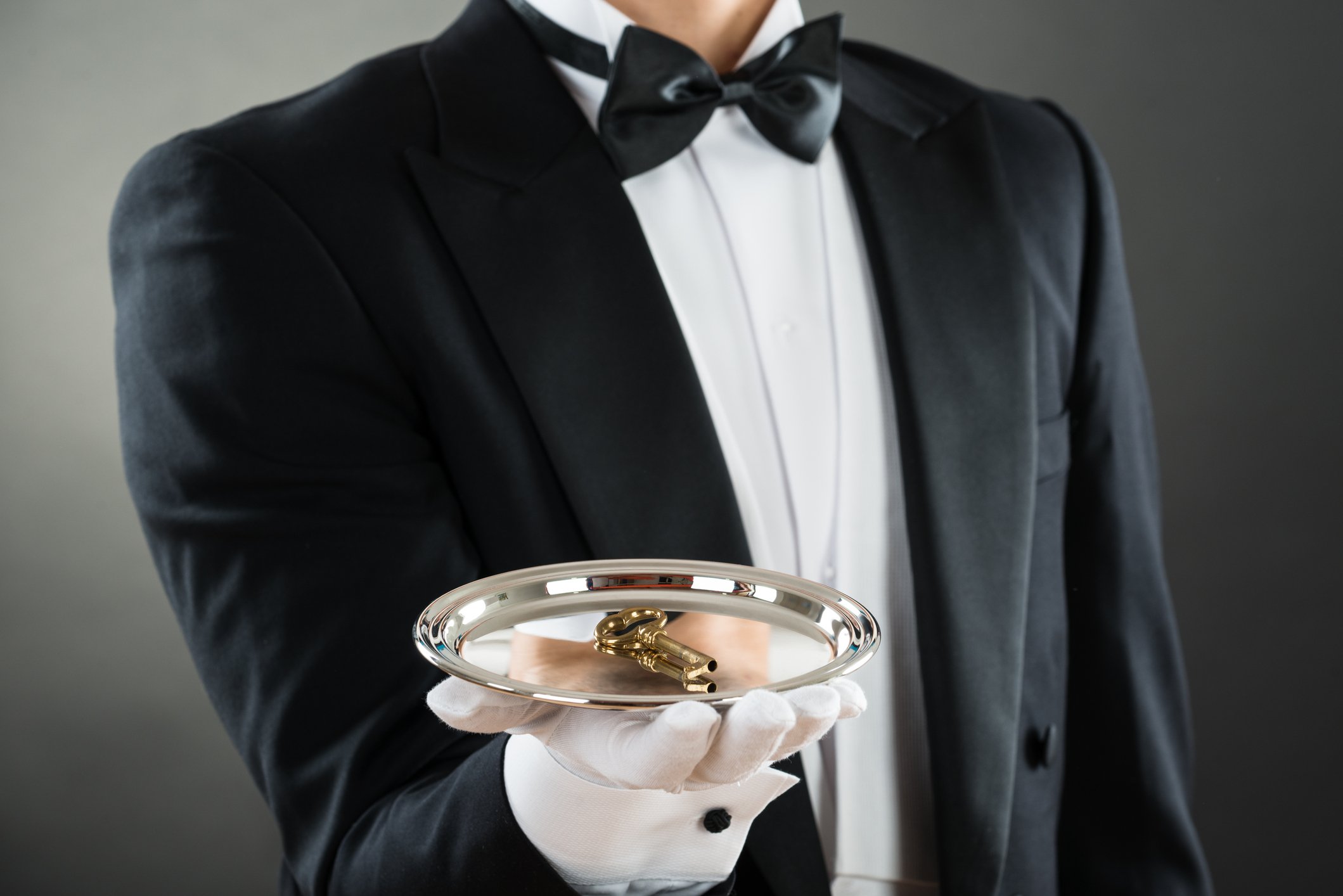 Waiter holding tray with key