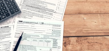 tax forms with calculator_GettyImages-512524656
