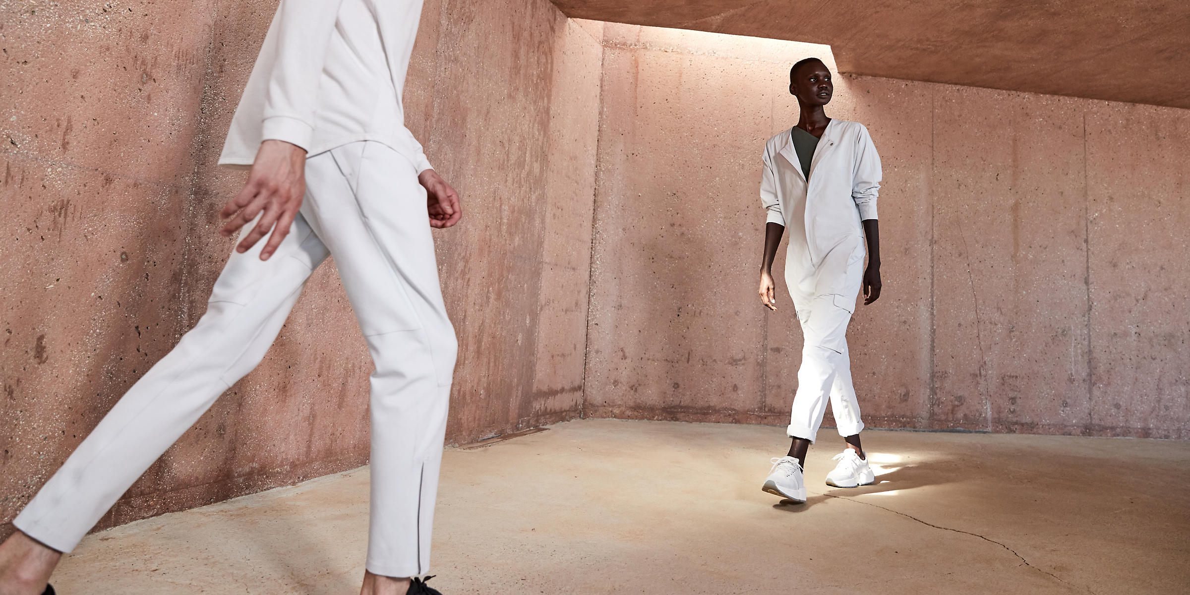 Two models wearing white clothing from Lululemon's new streetwear brand