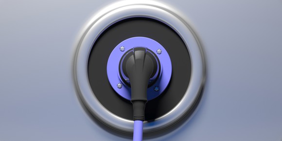 Electric vehicle plug shown plugged into a socket. 