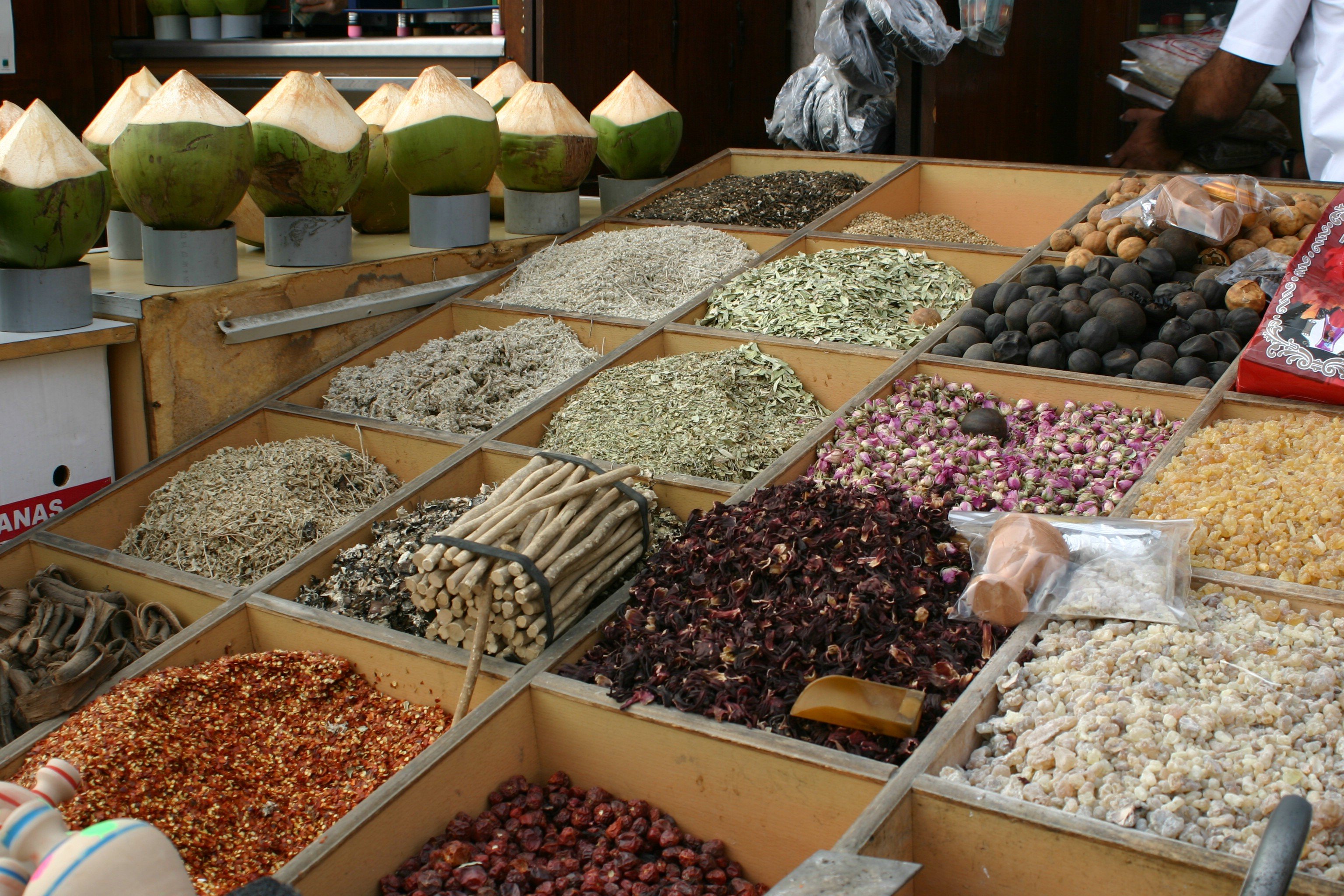 Bins containing raw spices of several different kinds.