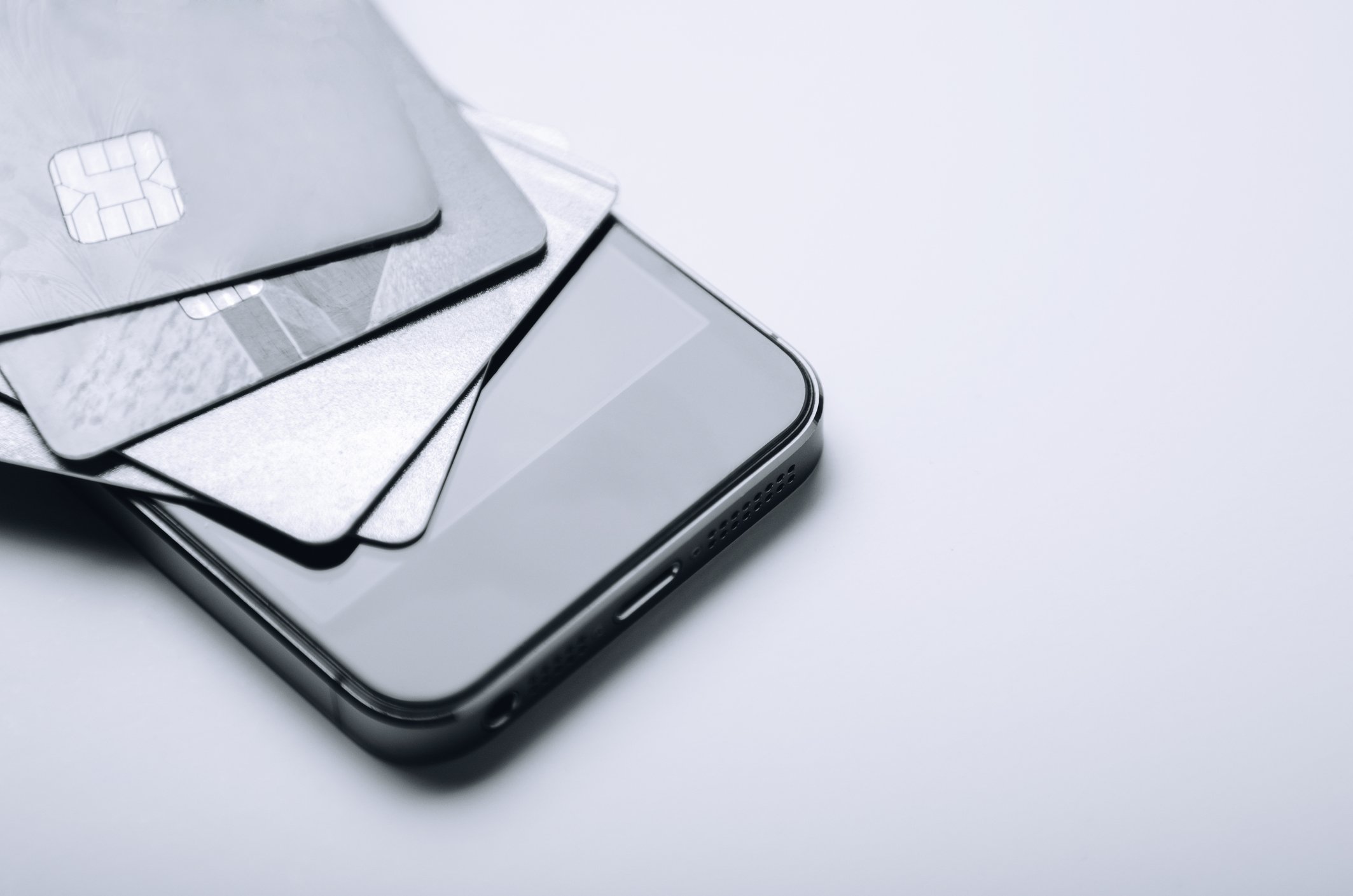 A smartphone with credit cards on top of it.