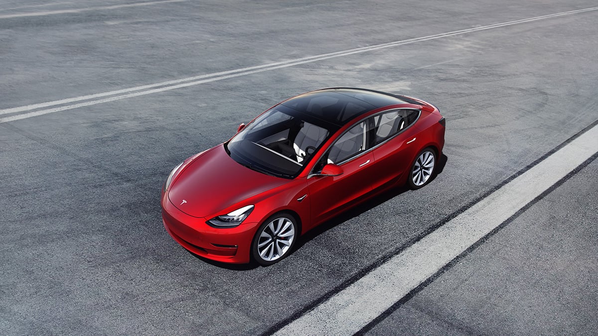 A red Tesla Model 3.