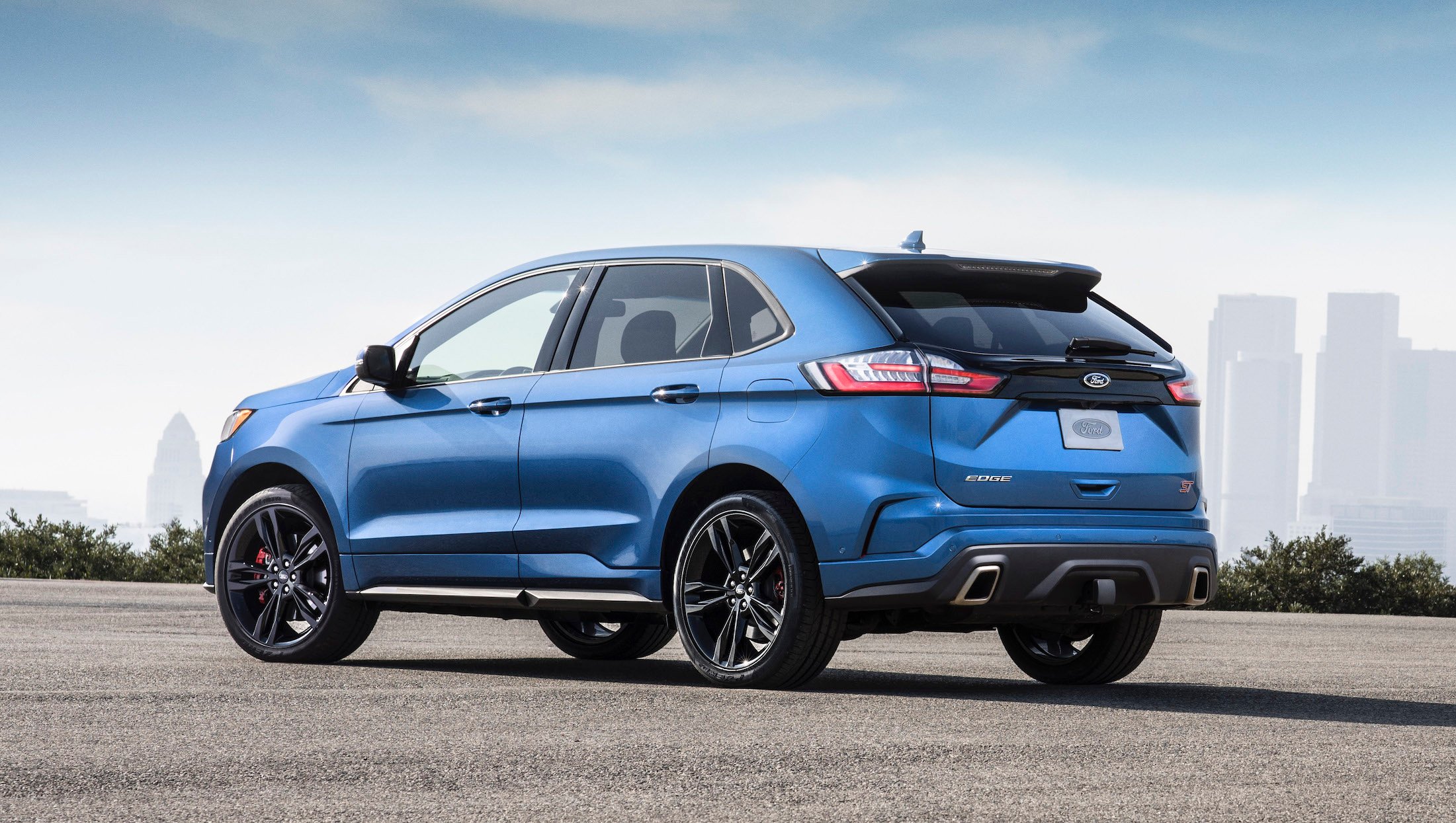 A blue Ford Edge ST, a high-performance midsize crossover SUV.