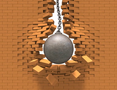 Wrecking ball going through a brick wall