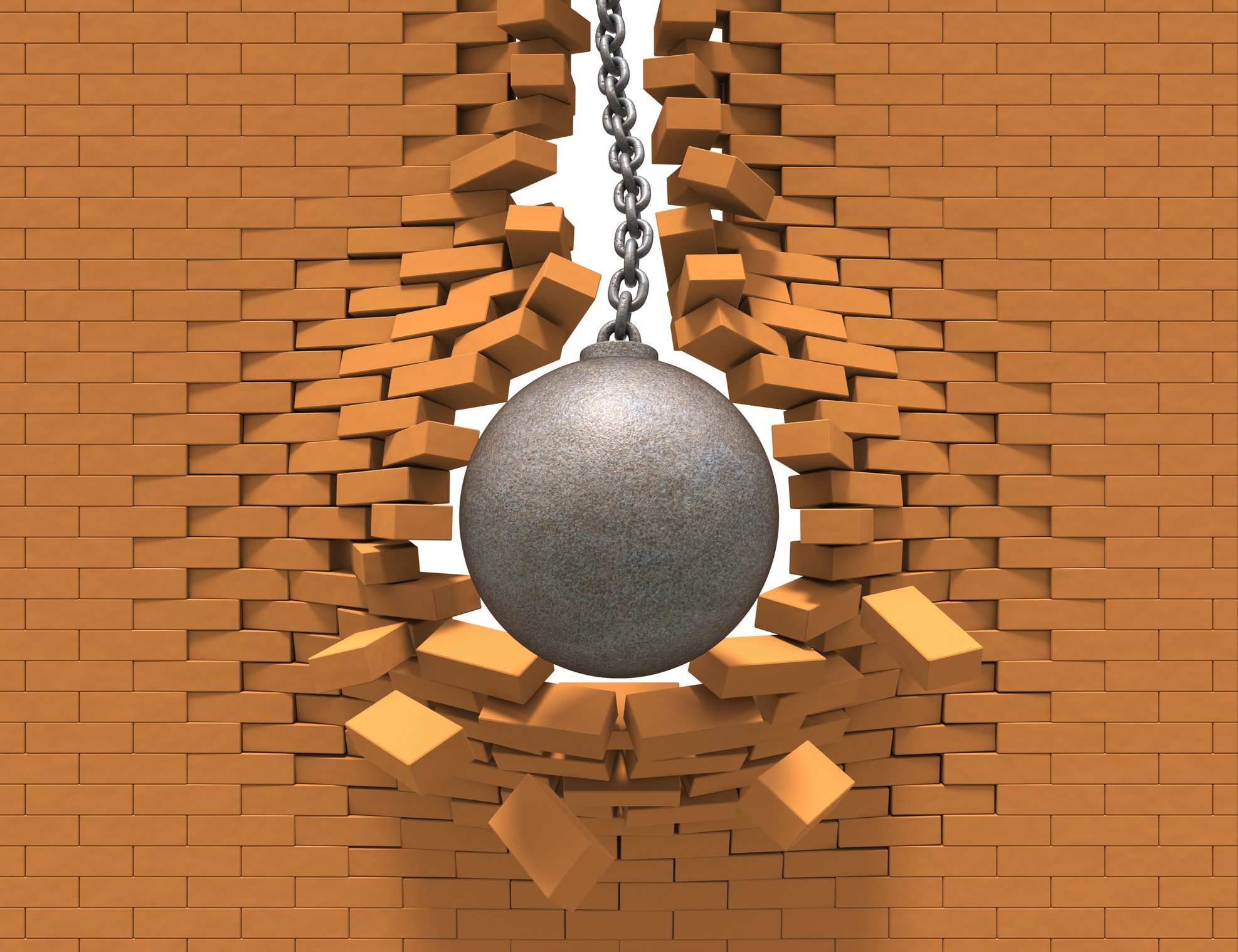 Wrecking ball going through a brick wall.