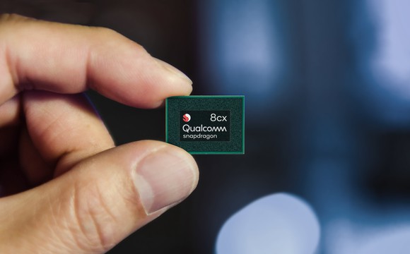 Hand holding up a Snapdragon 8cx chip