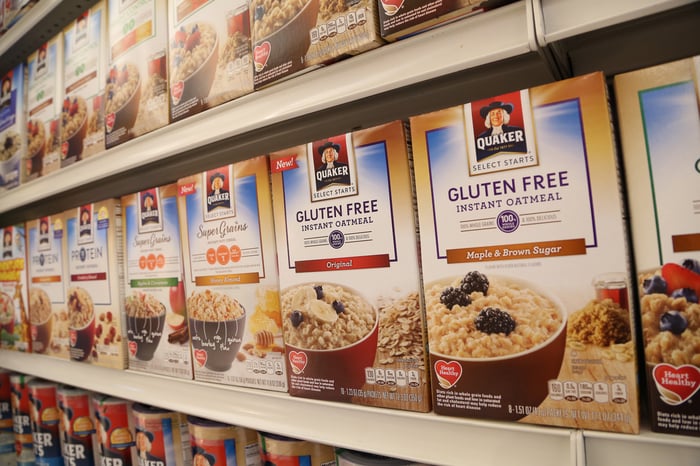 Several of PepsiCo's Quaker Oats boxes sitting on a store shelf.