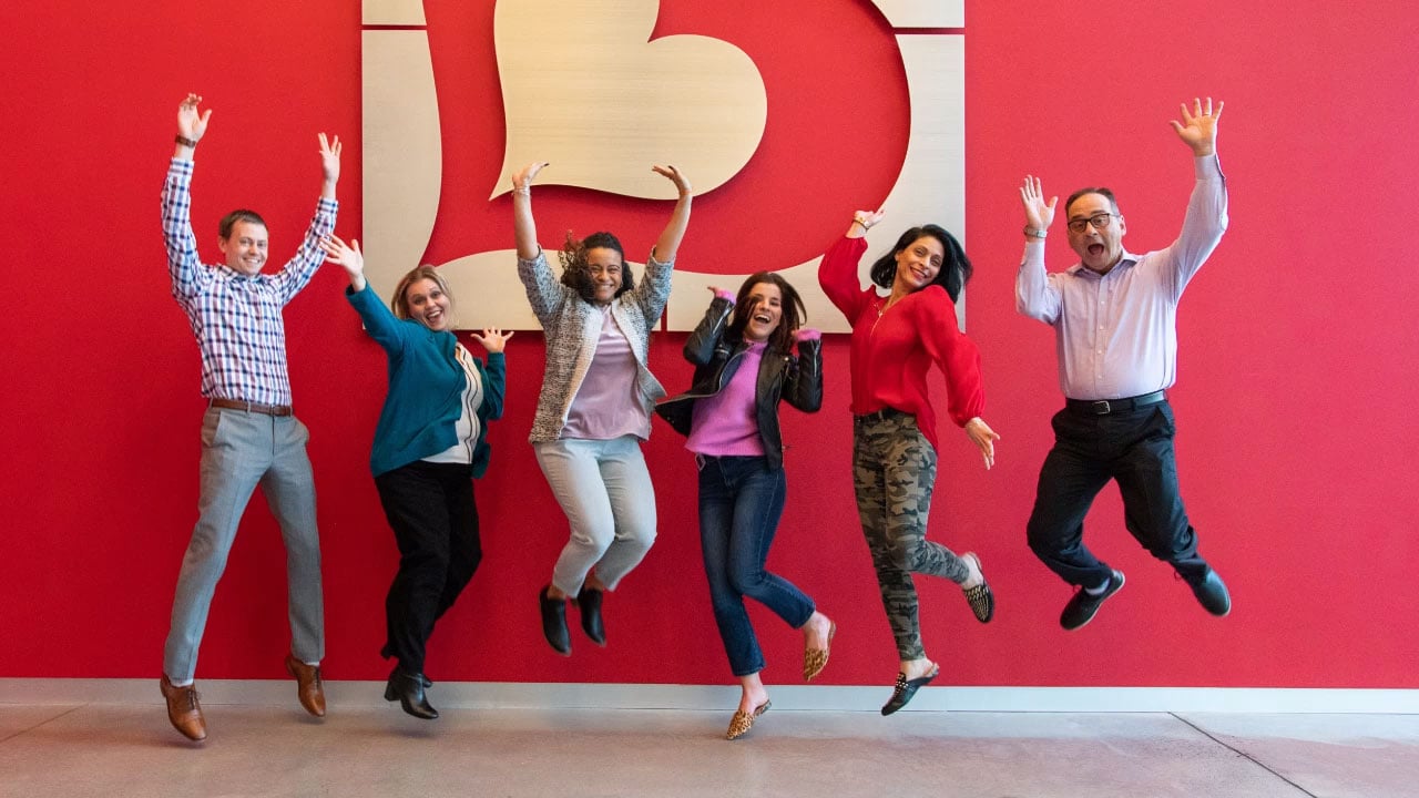 Burlington employees jumping in the air